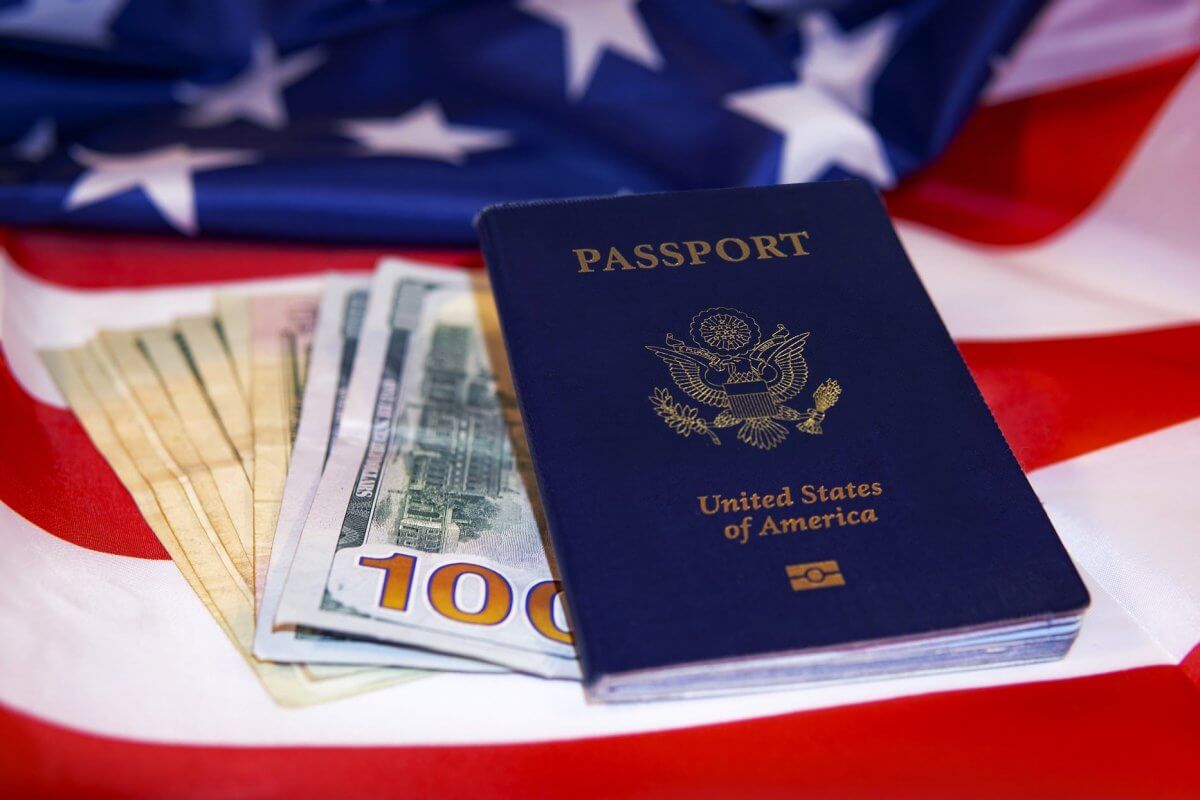 United States passport with cash on the American flag